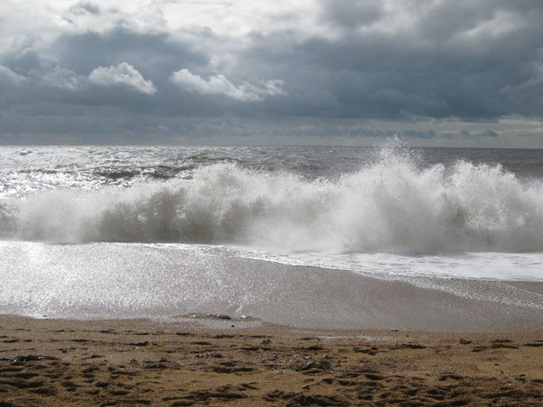 waves crashing onto shingle beach