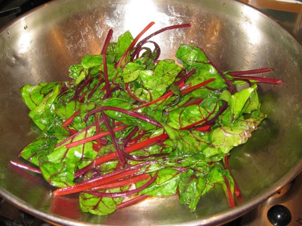 stir-fried beetroot leaves and chard in a wok