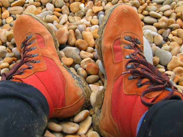 walking boots on pebble beach