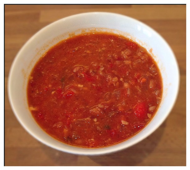 a bowl of spicy chorizo, bean and tomato soup