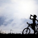 Female cyclist drinking water to demonstrate testosterone deficiency in women